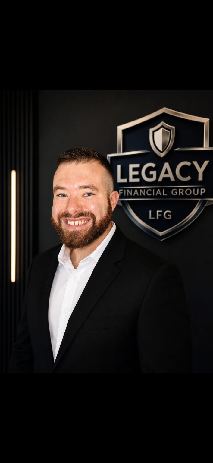 Timothy Thompson beside the Legacy Financial Group sign